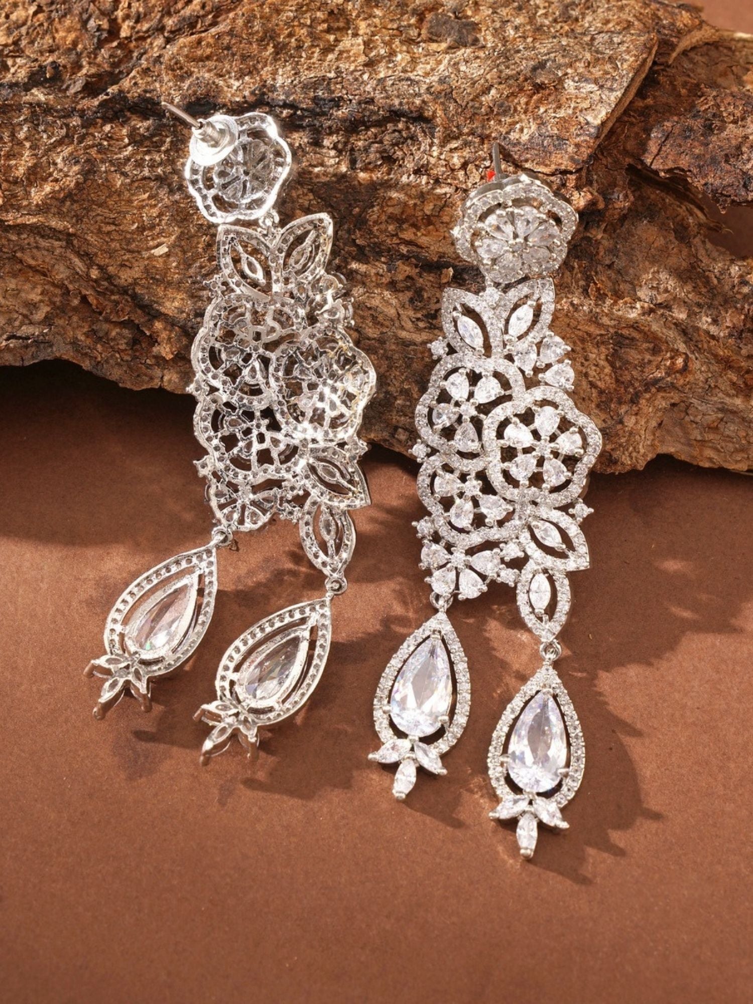 Abdesigns Jewellery Silver Floral Drop Earrings with intricate leaf and teardrop design on brown background