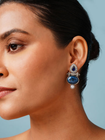Abdesigns Jewellery Silver Plated Blue Stone Pearl Earrings worn by woman with blue background