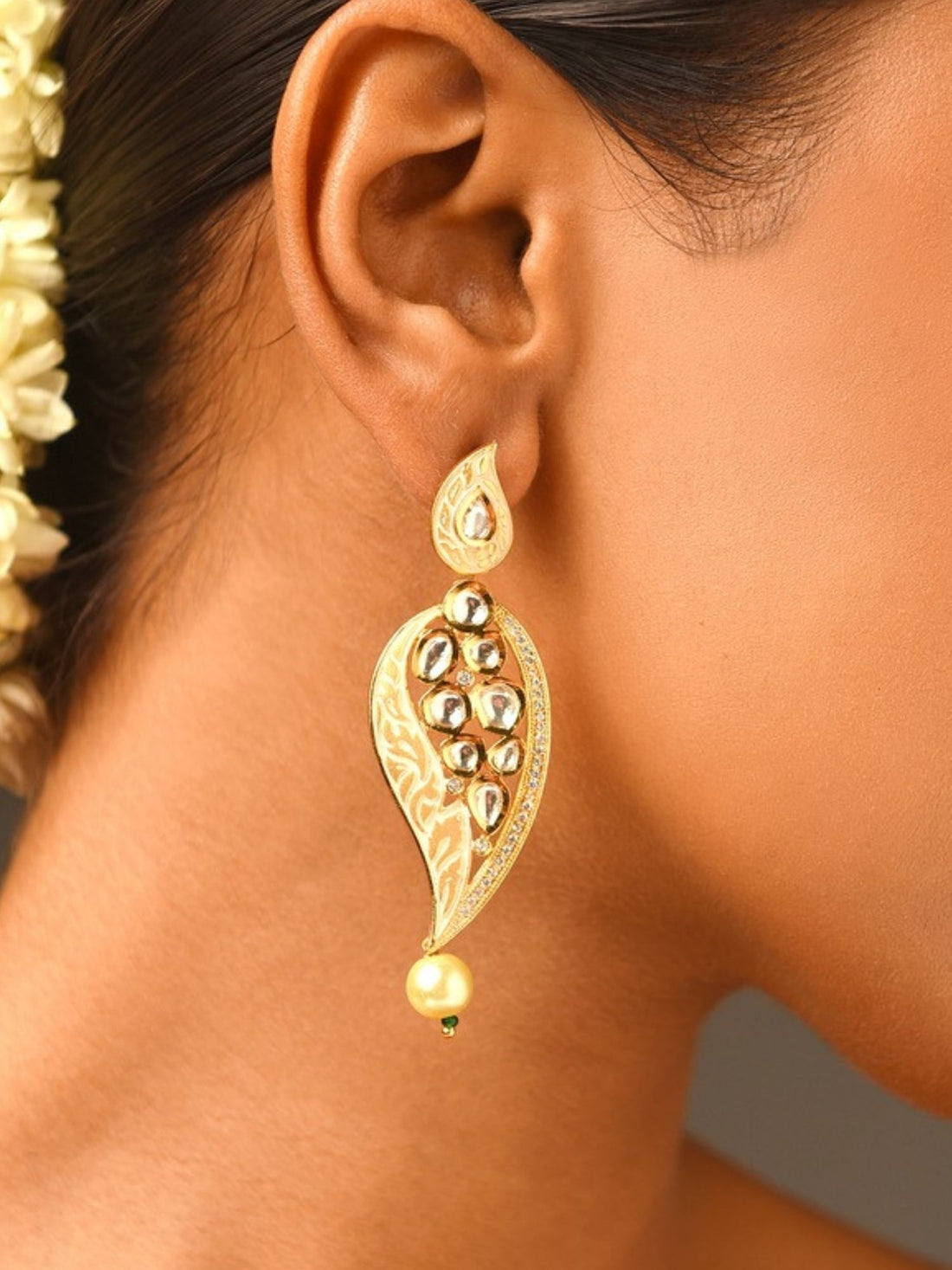 Woman wearing Abdesigns Jewellery Simple Gold Plated Kundan Earrings with intricate leaf design and pearl drop