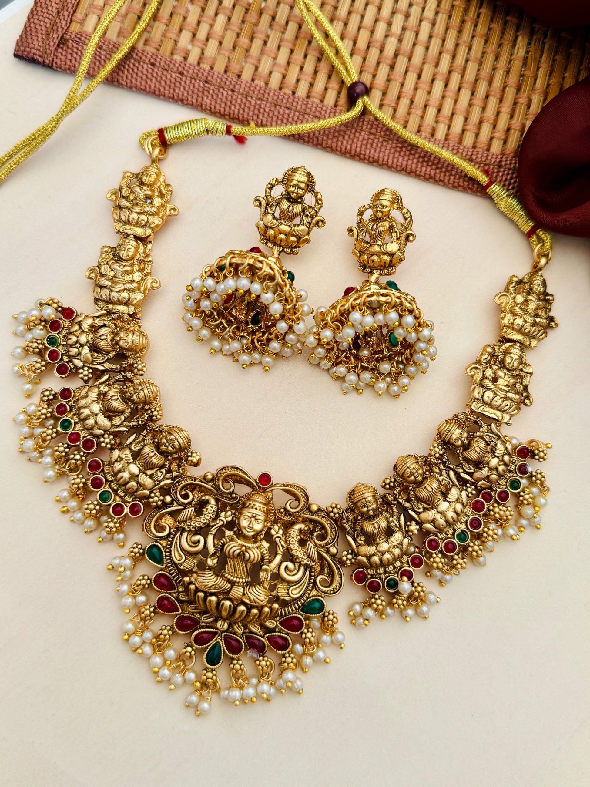 Abdesigns Jewellery Traditional Gold Necklace with Pearls featuring intricate deity motifs and matching earrings
