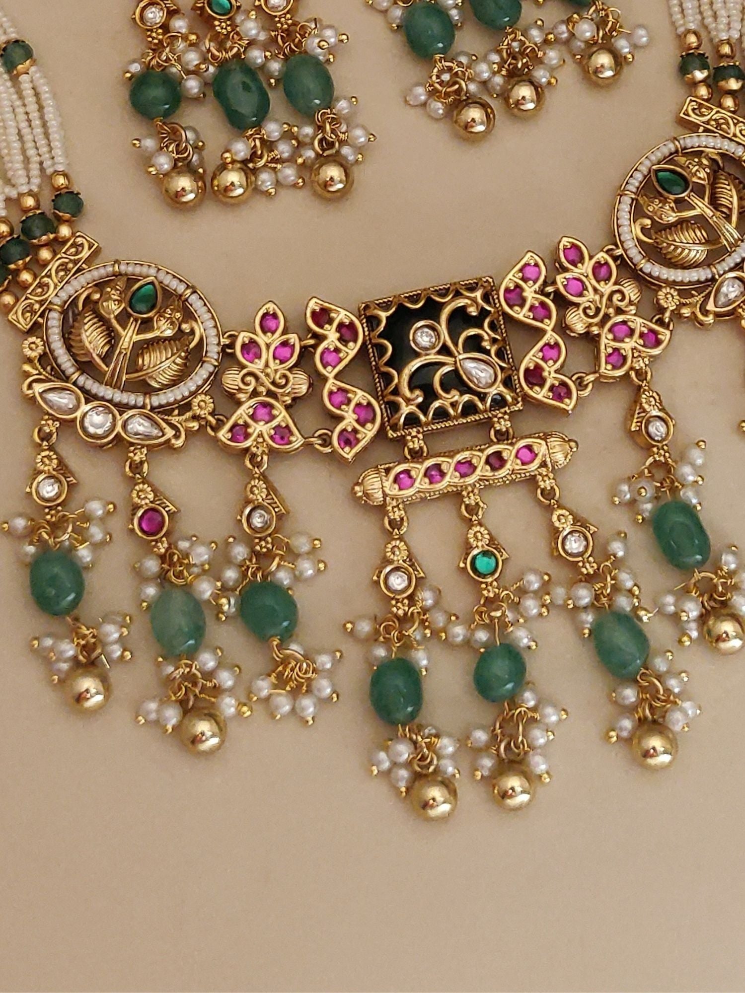 Abdesigns Jewellery Traditional Necklace Set with Earrings featuring gold tones, green and pink stones, and intricate designs
