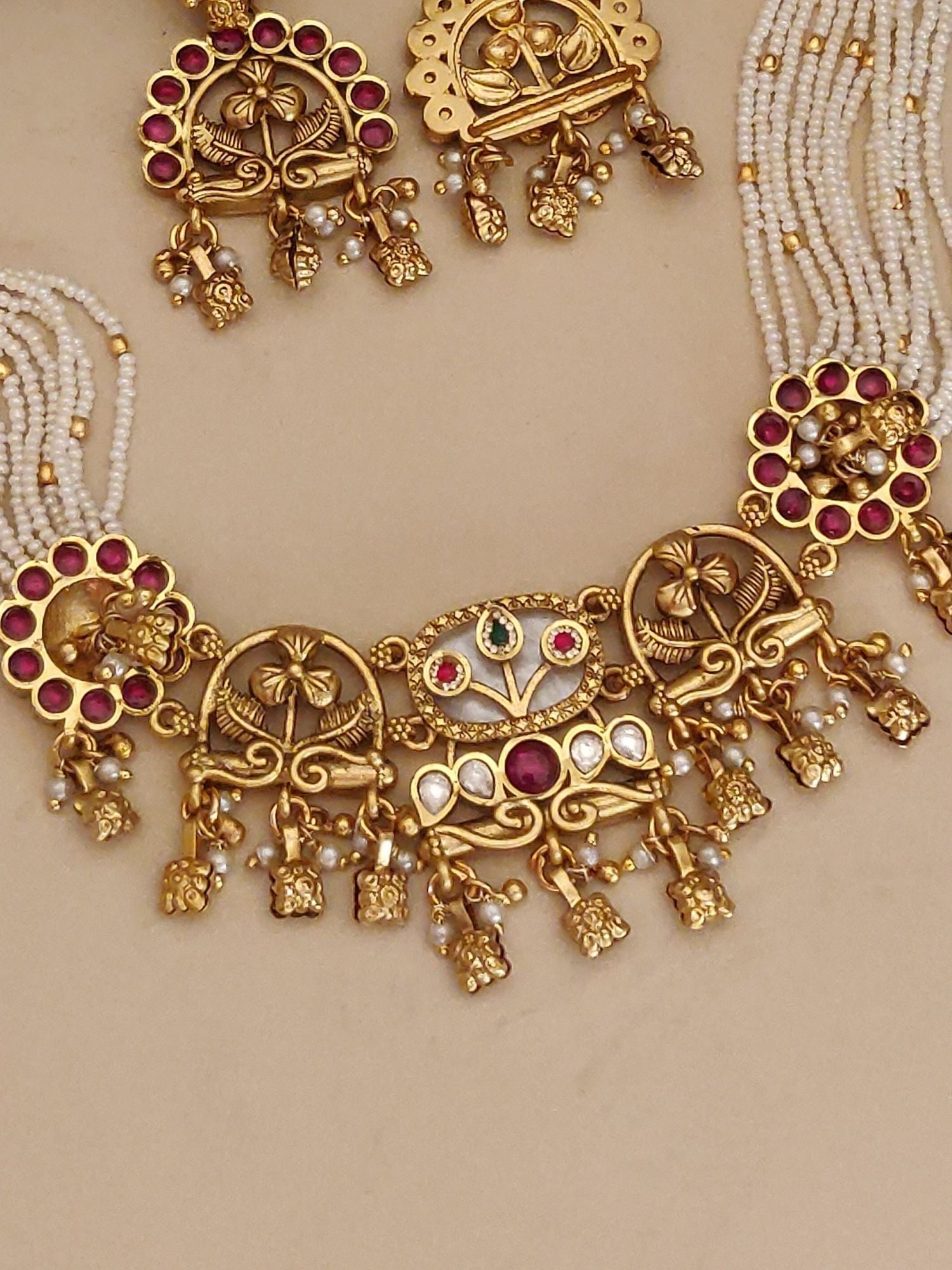 Abdesigns Jewellery Traditional Pearl Gold Necklace Set with intricate floral design and red gemstone accents