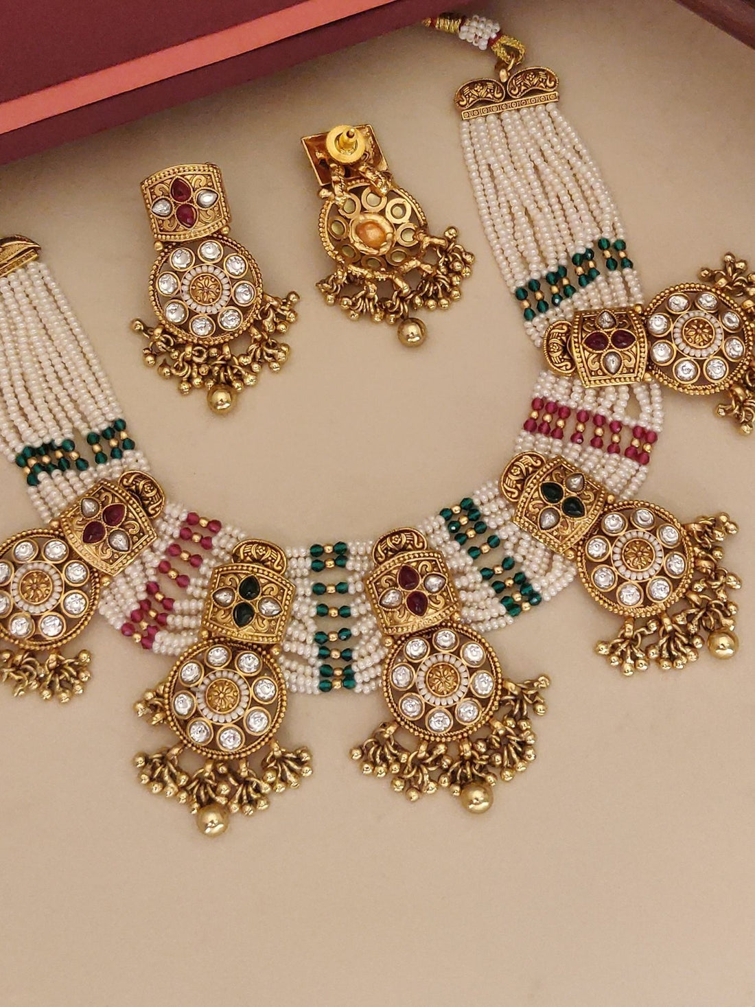 Abdesigns Jewellery Traditional Pearl Kundan Necklace Set featuring intricate gold and pearl design with green and red accents