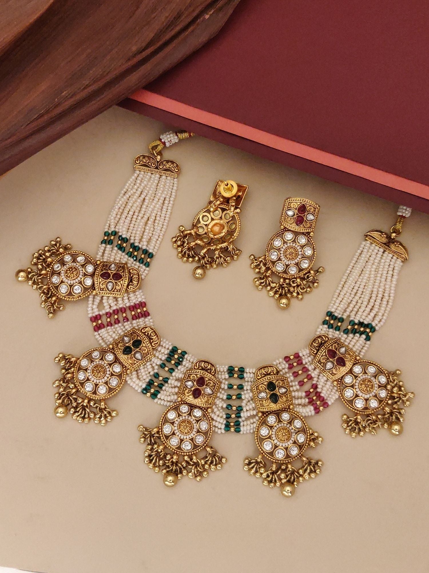 Abdesigns Jewellery Traditional Pearl Kundan Necklace Set featuring intricate gold and pearl design with green and red accents