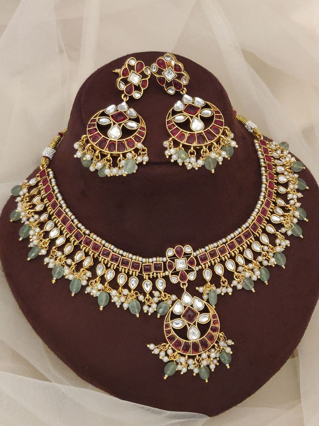 Gold kundan necklace and matching earrings with maroon enamel green beads and pearl drops luxury Indian bridal jewelry set