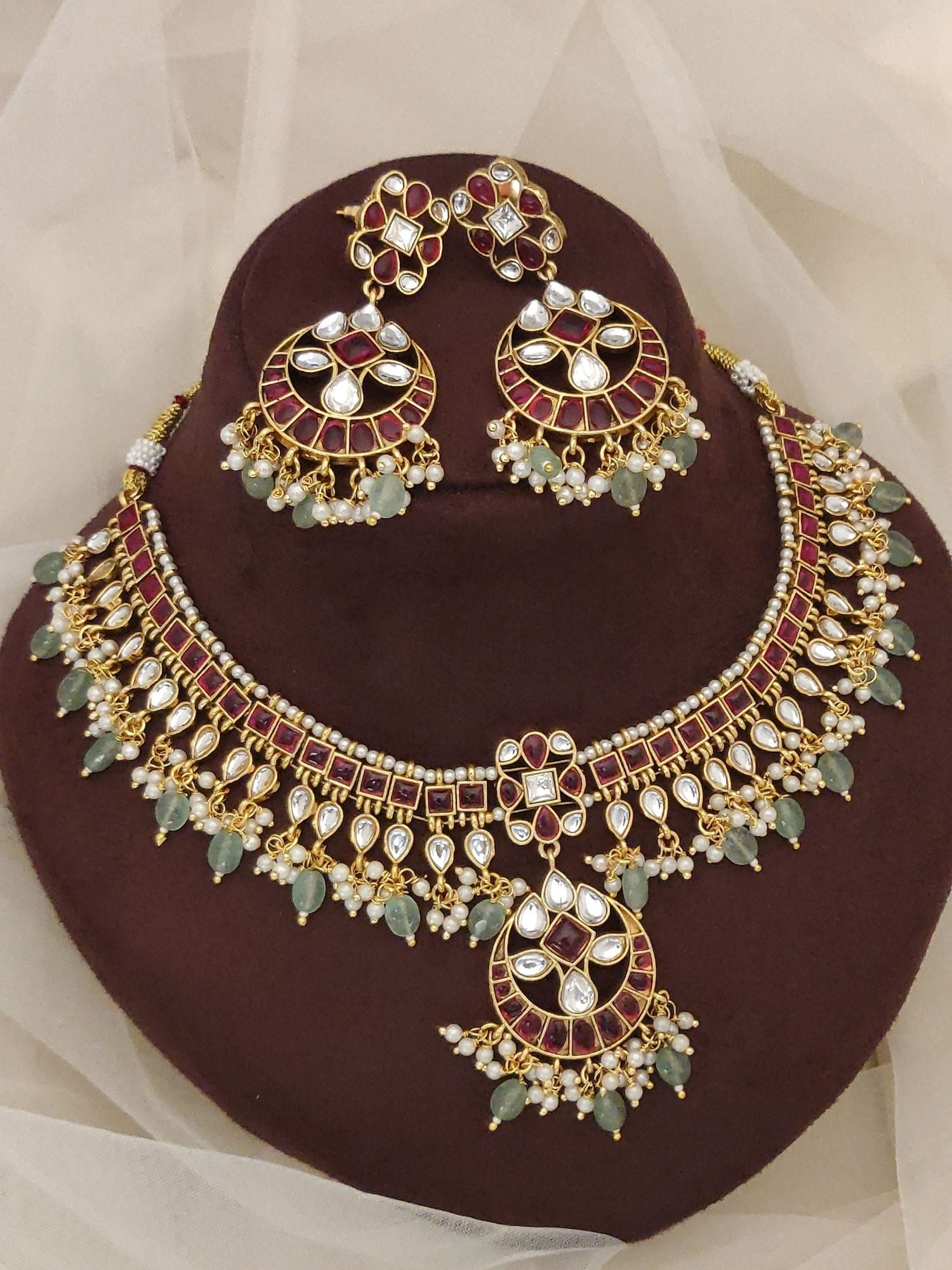 Gold kundan necklace and matching earrings with maroon enamel green beads and pearl drops luxury Indian bridal jewelry set