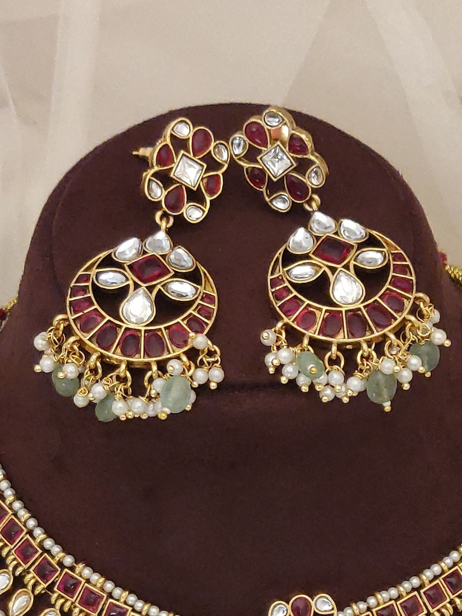 luxury Indian bridal jewelry set gold kundan necklace and chandbali earrings with red enamel white stones and pearl drops