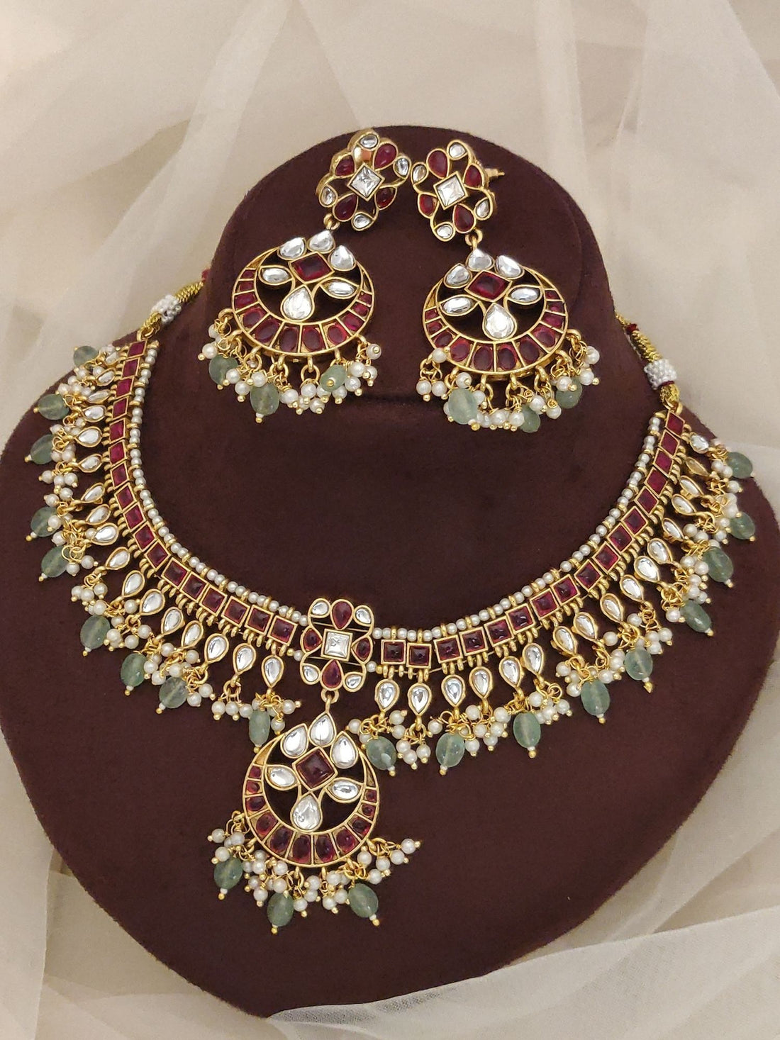 Gold kundan necklace and matching earrings with maroon enamel green beads and pearl drops luxury Indian bridal jewelry set