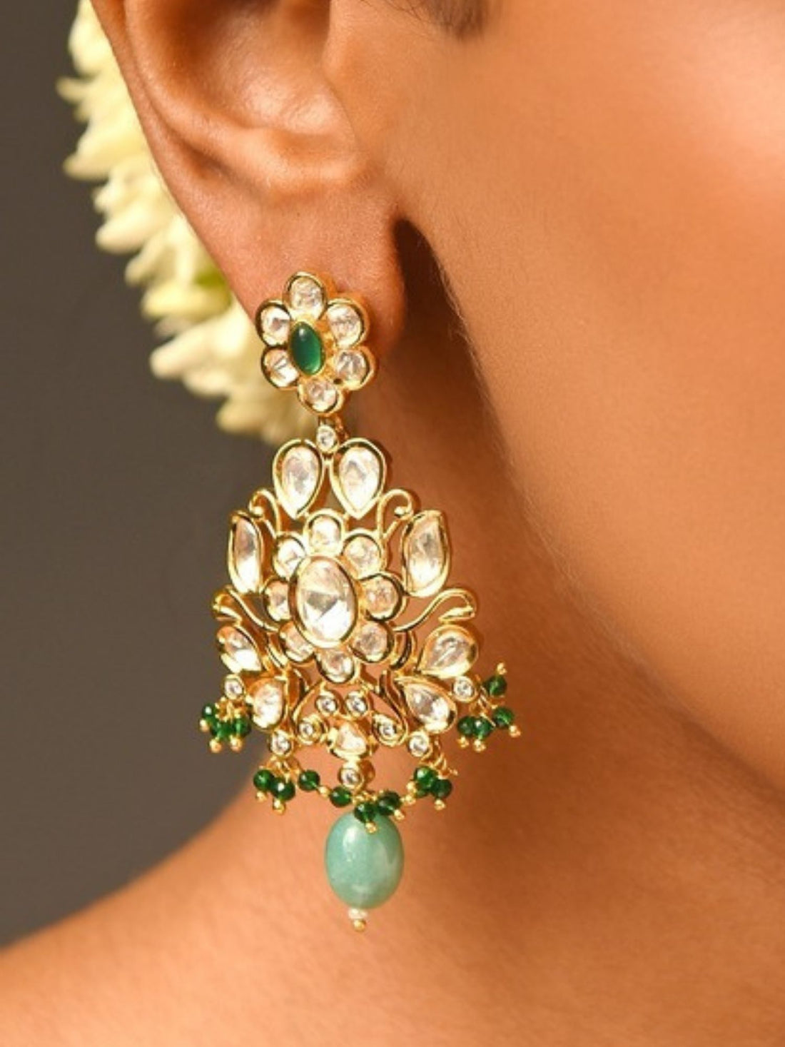 Woman wearing Majestic Gold Plated Kundan Polki Earrings with green and white stones by Abdesignsjewellery
