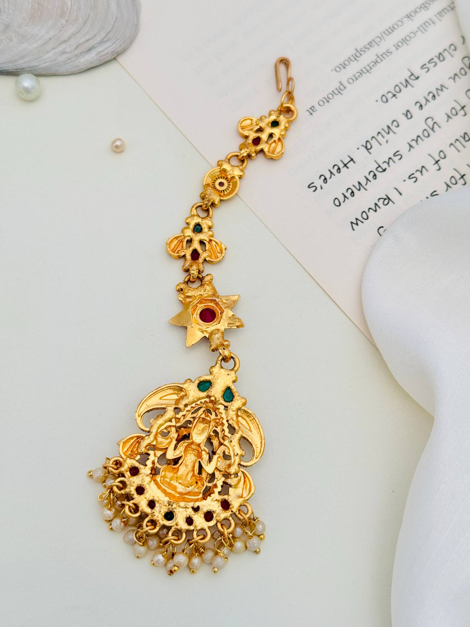 Matt Gold Plated Goddess Laxmi SouthIndian Maangtikka with intricate design and pearl details by Abdesignsjewellery