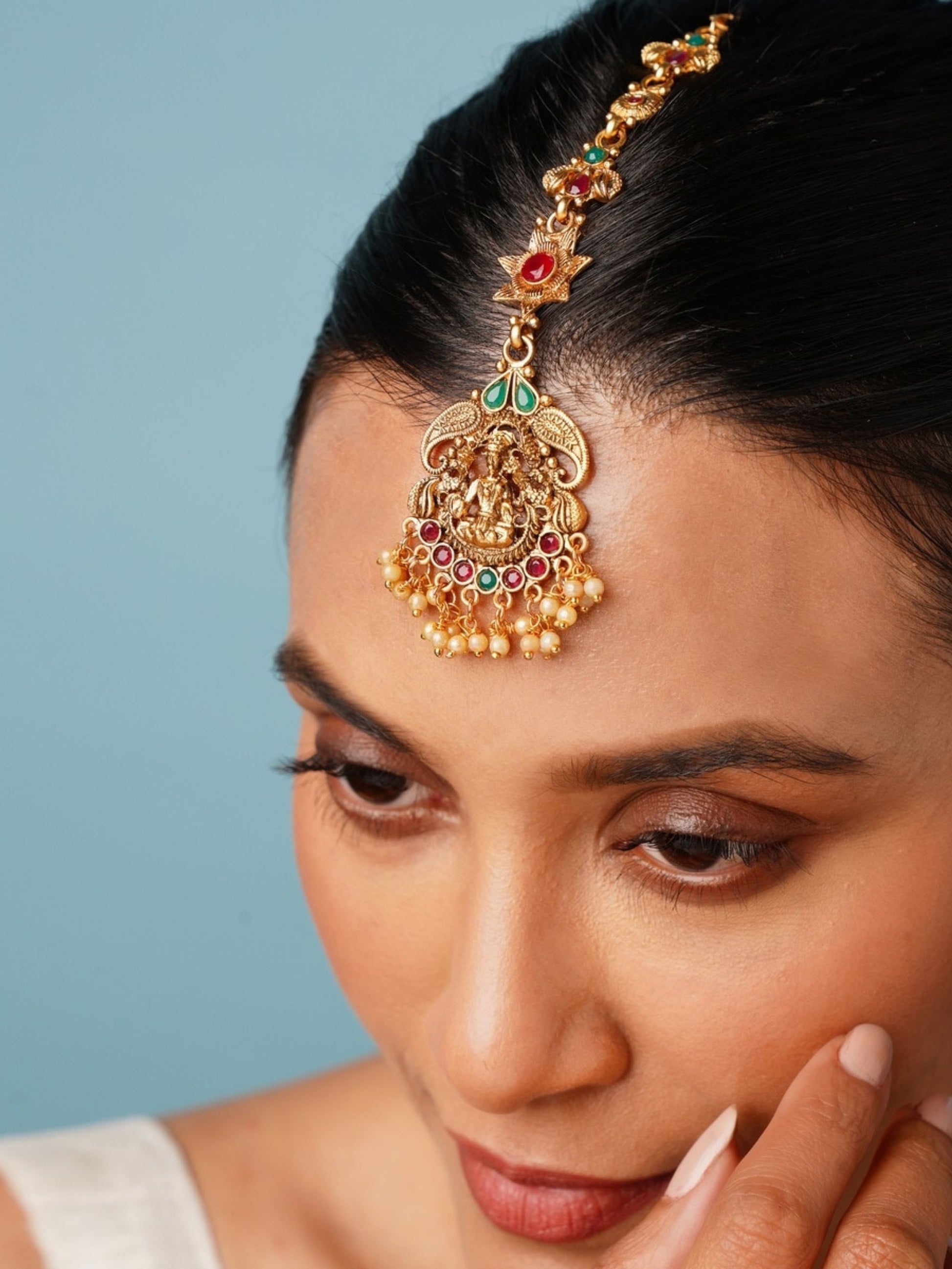 Matt Gold Plated Goddess Laxmi SouthIndian Maangtikka worn on forehead with intricate design and colored stones