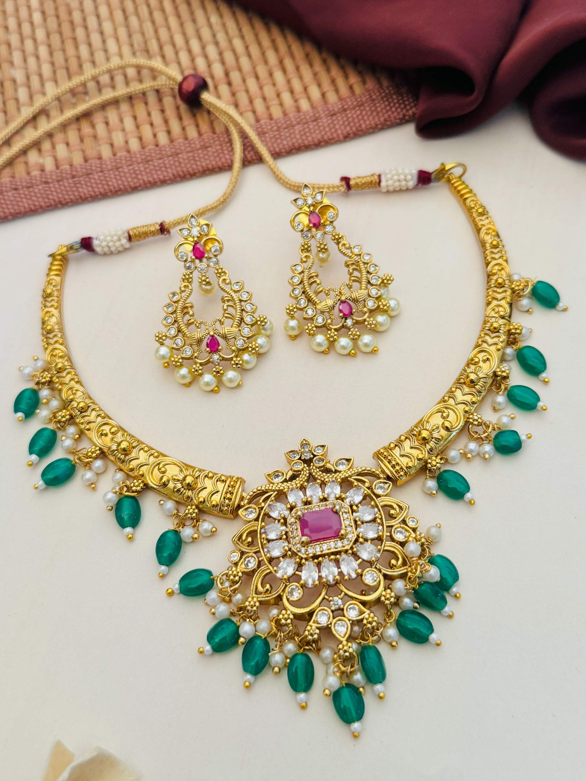 Matt Gold Plated Temple Necklace Set with intricate design featuring green beads and matching earrings