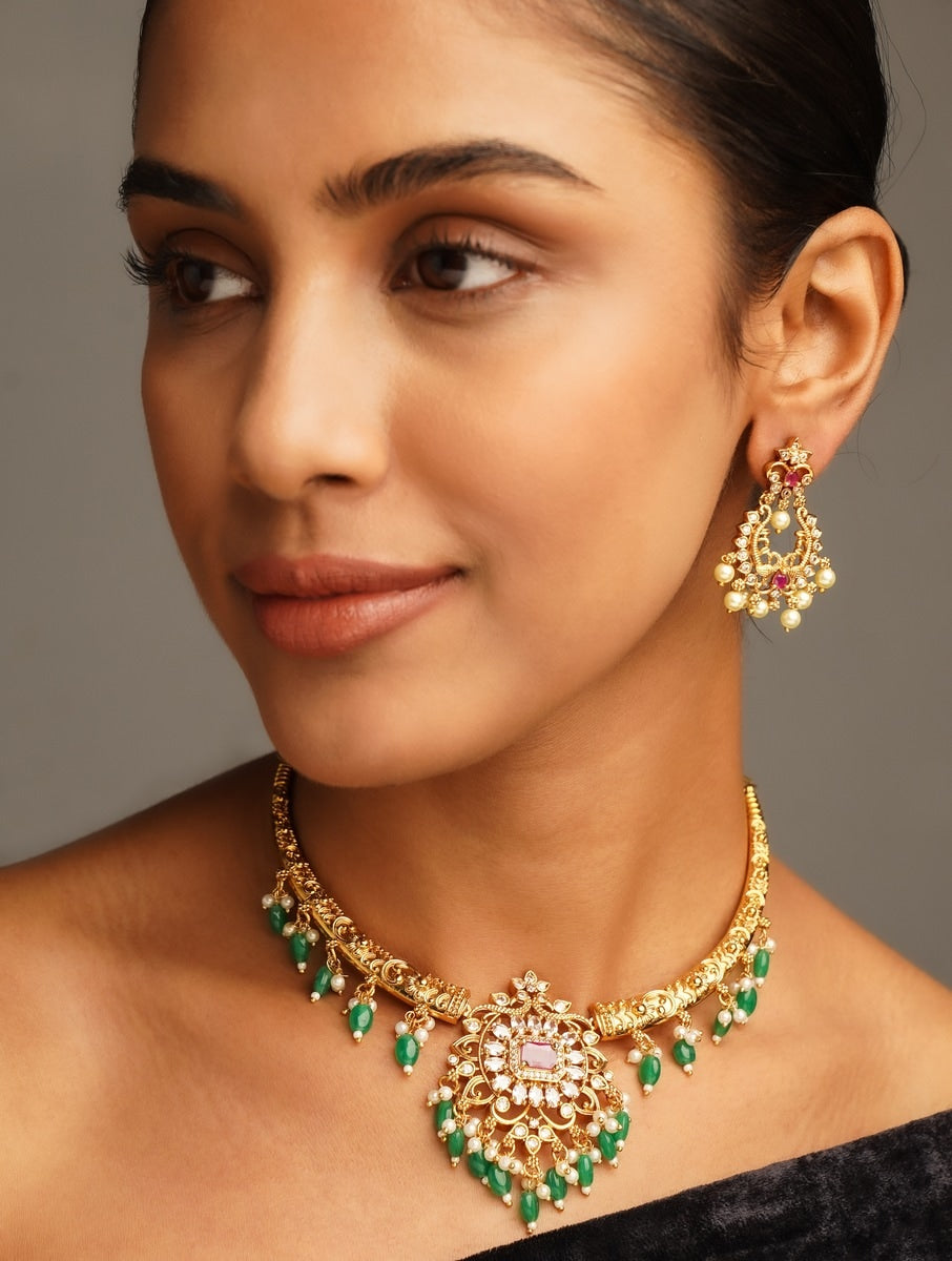 Matt Gold Plated Temple Necklace Set with green beads and matching earrings on woman