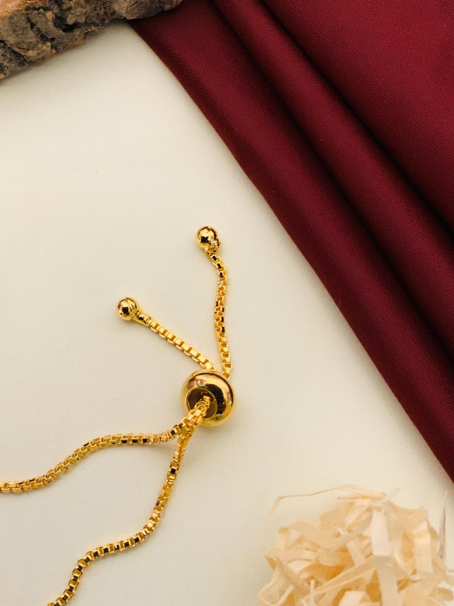 Abdesignsjewellery minimal gold plated bracelet adjustable slider chain with box links and bead ends on cream backdrop