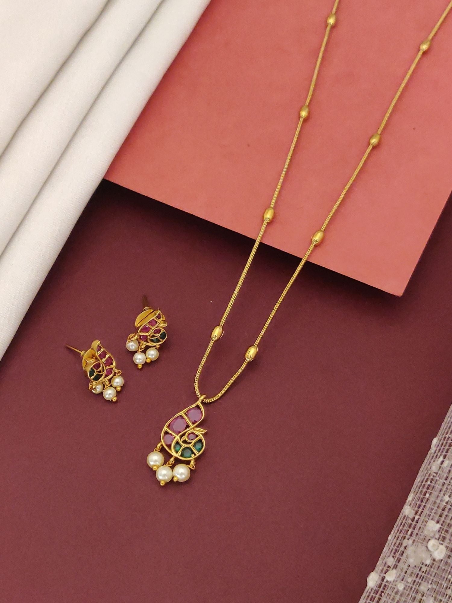 Minimal Gold Plated Kemp Stone Peacock Necklace Set featuring peacock pendant with pearls and matching earrings on beaded chain