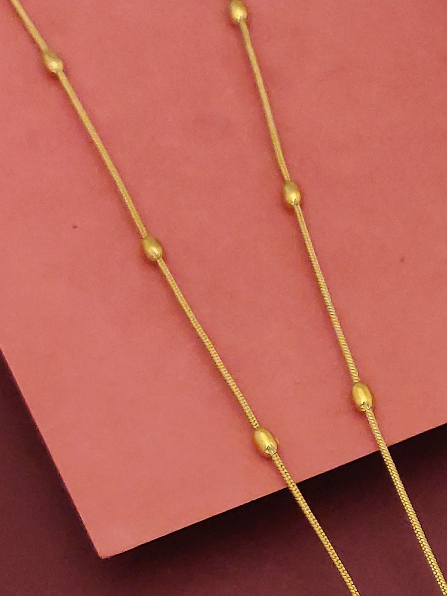 Minimal Gold Plated Kemp Stone Peacock Necklace Set thin gold chain with spaced bead accents on pink background