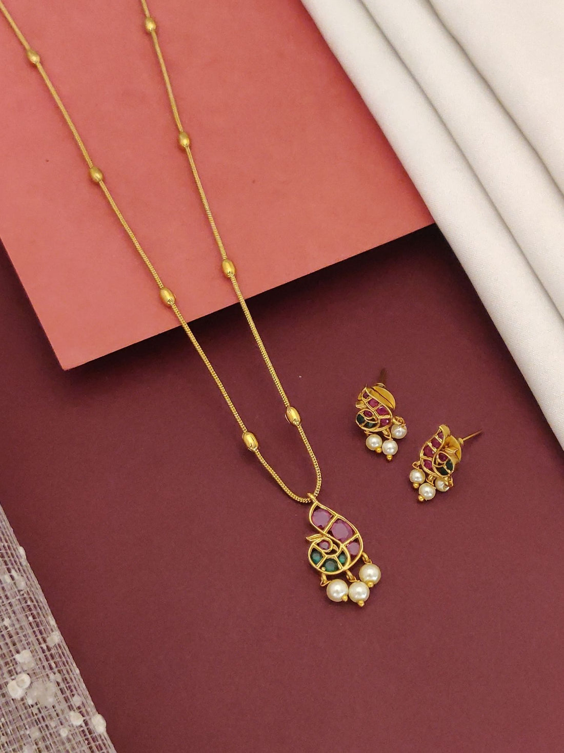 Minimal Gold Plated Kemp Stone Peacock Necklace Set by Abdesignsjewellery with peacock pendant and matching pearl drop earrings