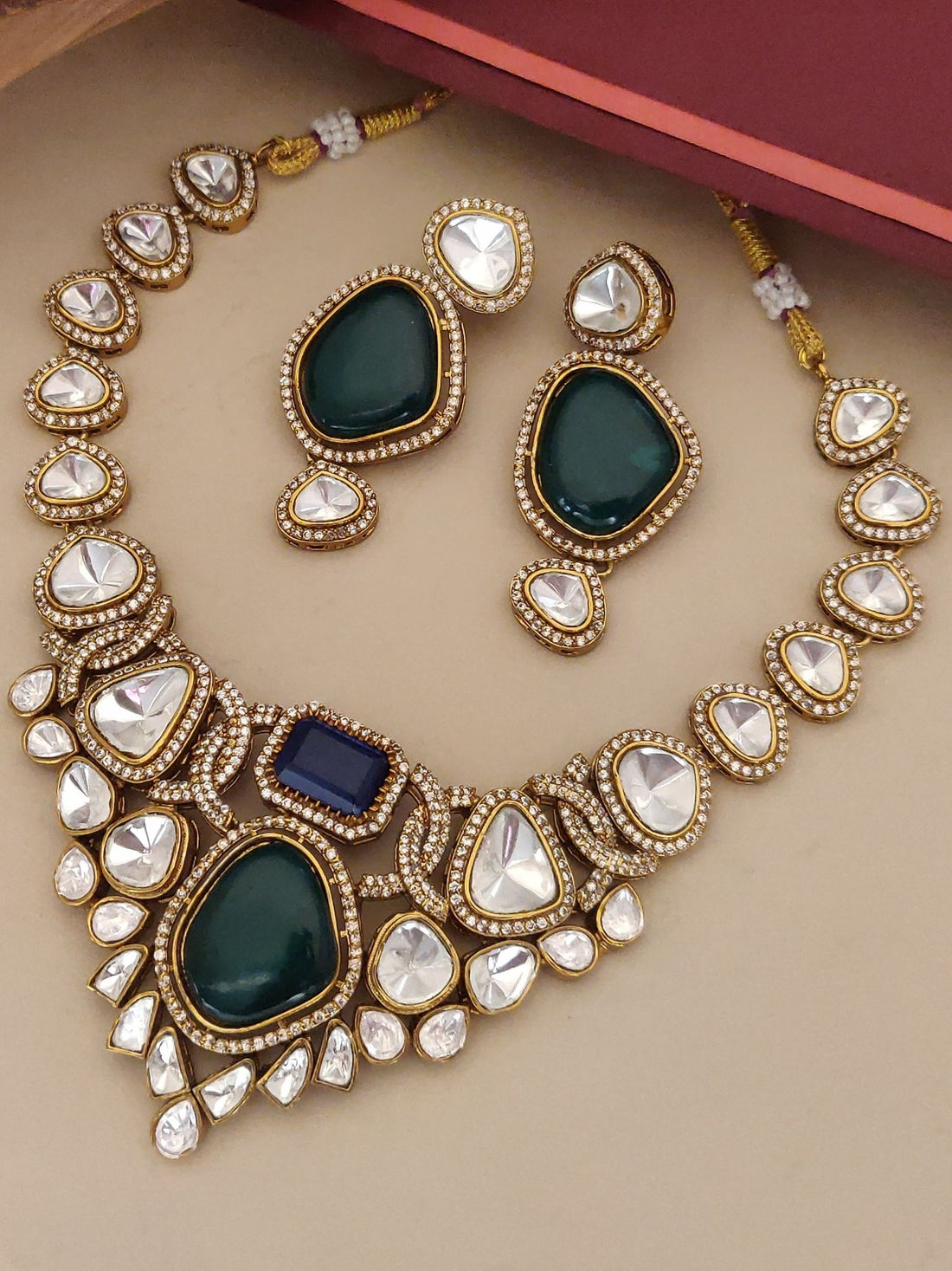Gold kundan necklace and matching earrings with green teardrops and blue accent stones multi color stone necklace for women