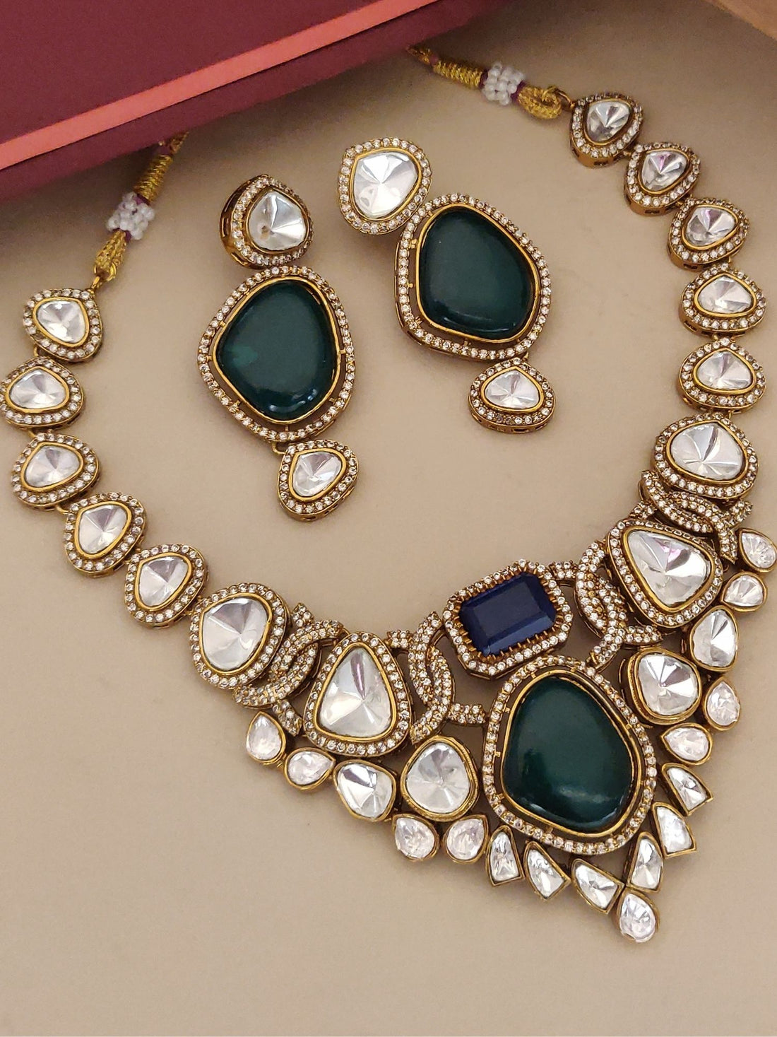 Gold kundan necklace and matching earrings with green teardrops and blue accent stones multi color stone necklace for women