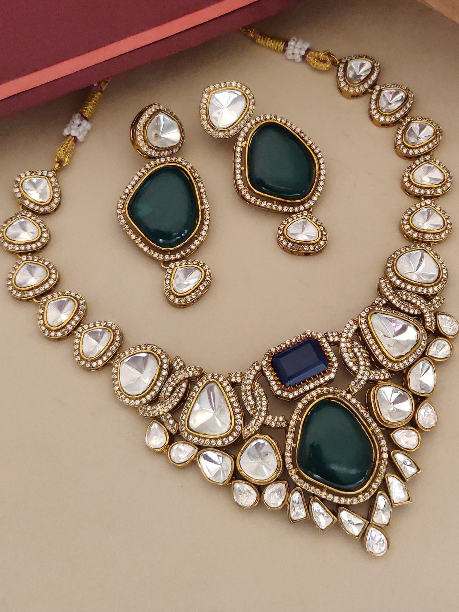 Gold kundan necklace and matching earrings with green teardrops and blue accent stones multi color stone necklace for women