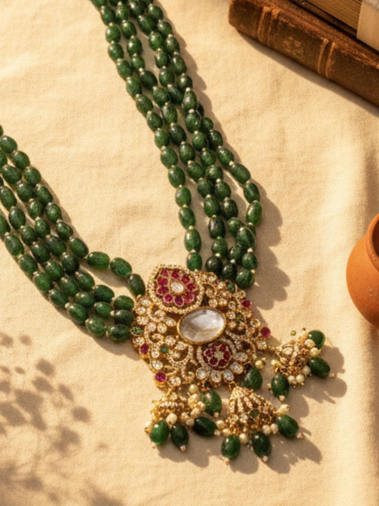 Elegant necklace emerald featuring multi-strand design with intricate gold and gemstone detailing