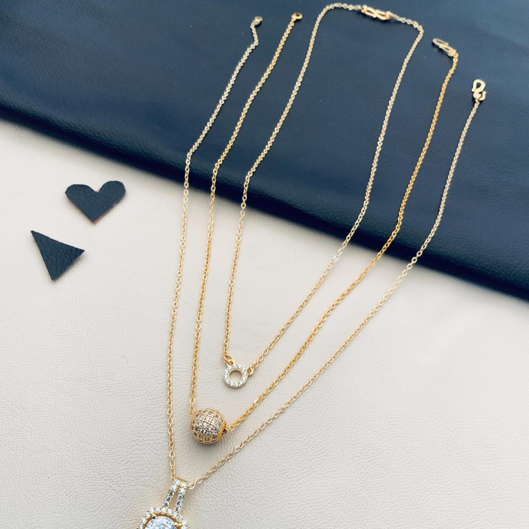 Layered gold pendant necklaces with halo drop and pave ball charms by Abdesignsjewellery penents daily wear fashion jewelry combo