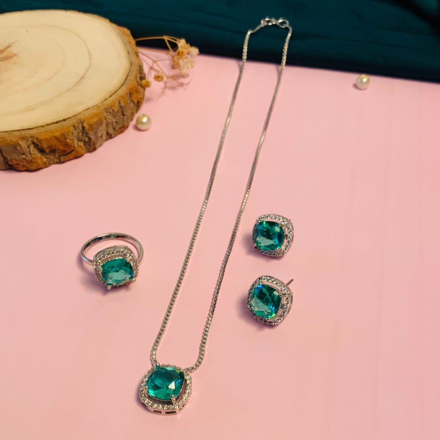 Precious Silver Plated Cz Pendant Chain Combo featuring green stone necklace ring and earrings set on pink background