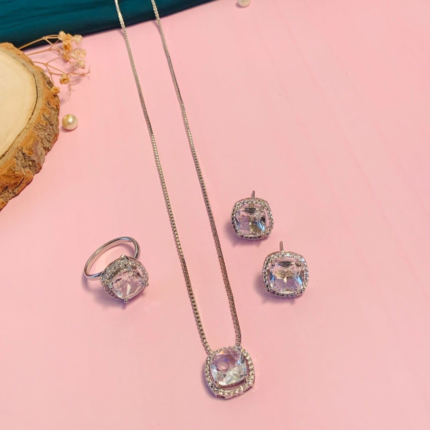 Abdesignsjewellery Precious Silver Plated Cz Pendant Chain Combo with ring and earrings set on pink background