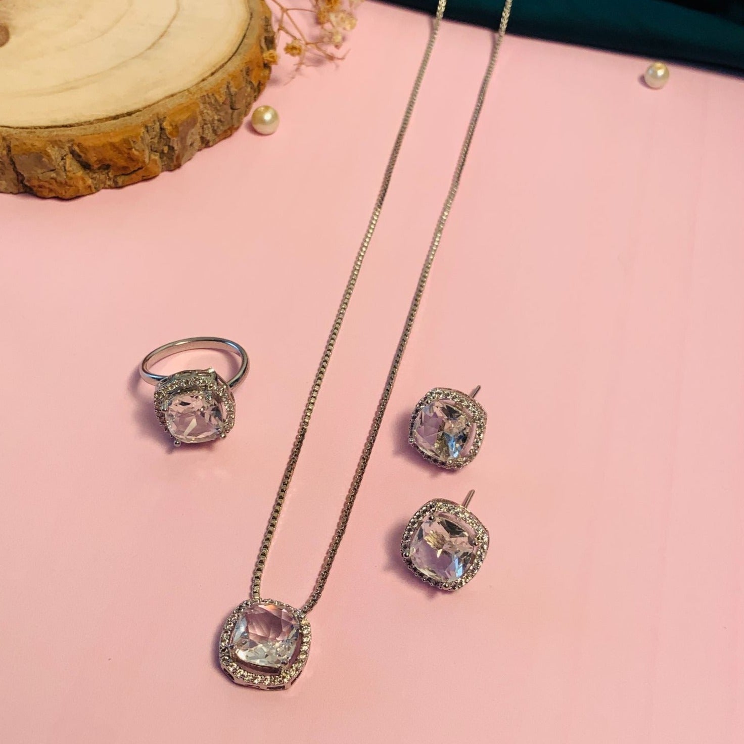 Precious Silver Plated Cz Pendant Chain Combo featuring necklace, ring, and earrings set on a pink background