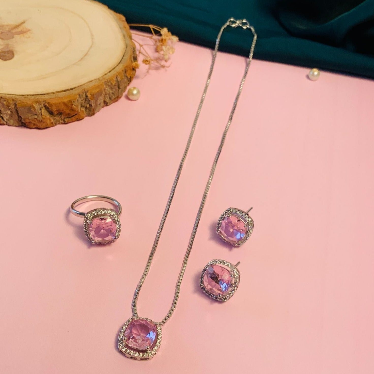 Precious Silver Plated Cz Pendant Chain Combo featuring pink gemstones with matching ring and earrings on pink background