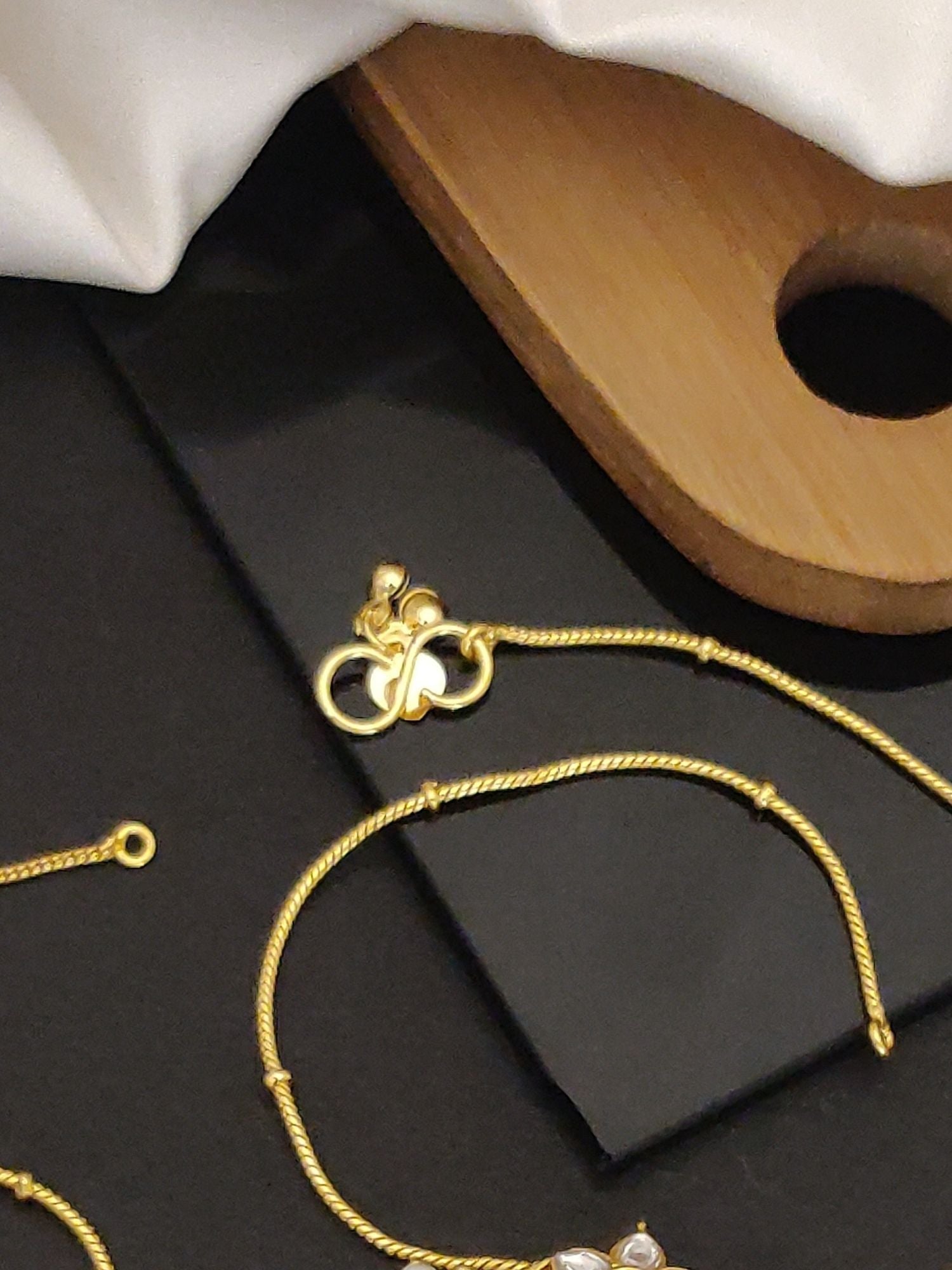 Premium Quality Over size Gold Plated Pachi Kundan Anklets. Abdesignsjewellery gold rope anklets with om charm on black backdrop