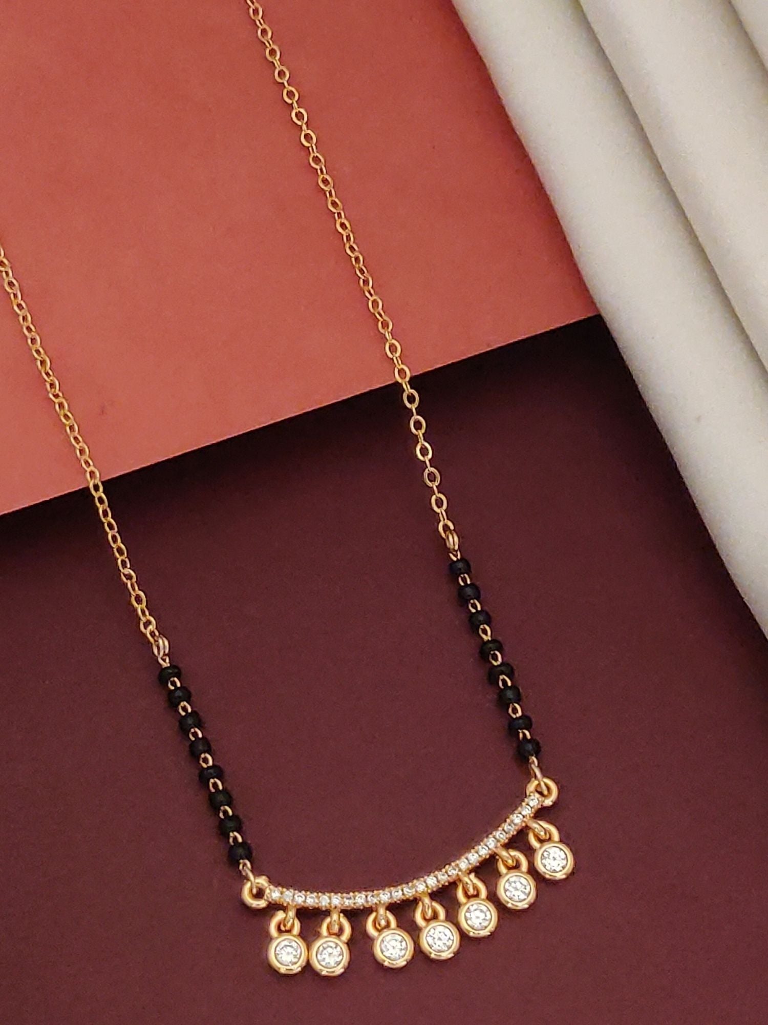 Rose Gold Plated American Diamond Mangalsutra by Abdesignsjewellery with black beads and seven dangling diamond stones