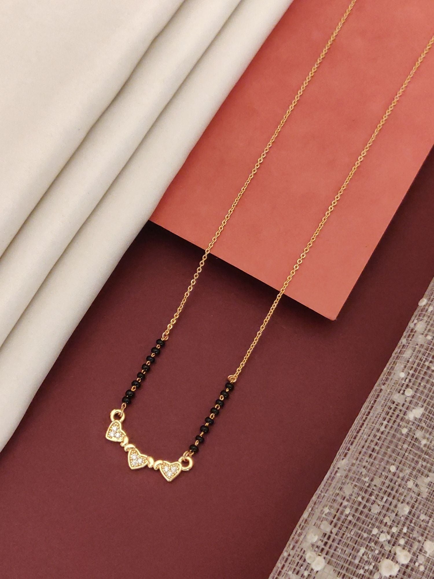 Abdesigns Rose Gold Plated Black Beads Mangalsutra with Heart Accents on Elegant Background