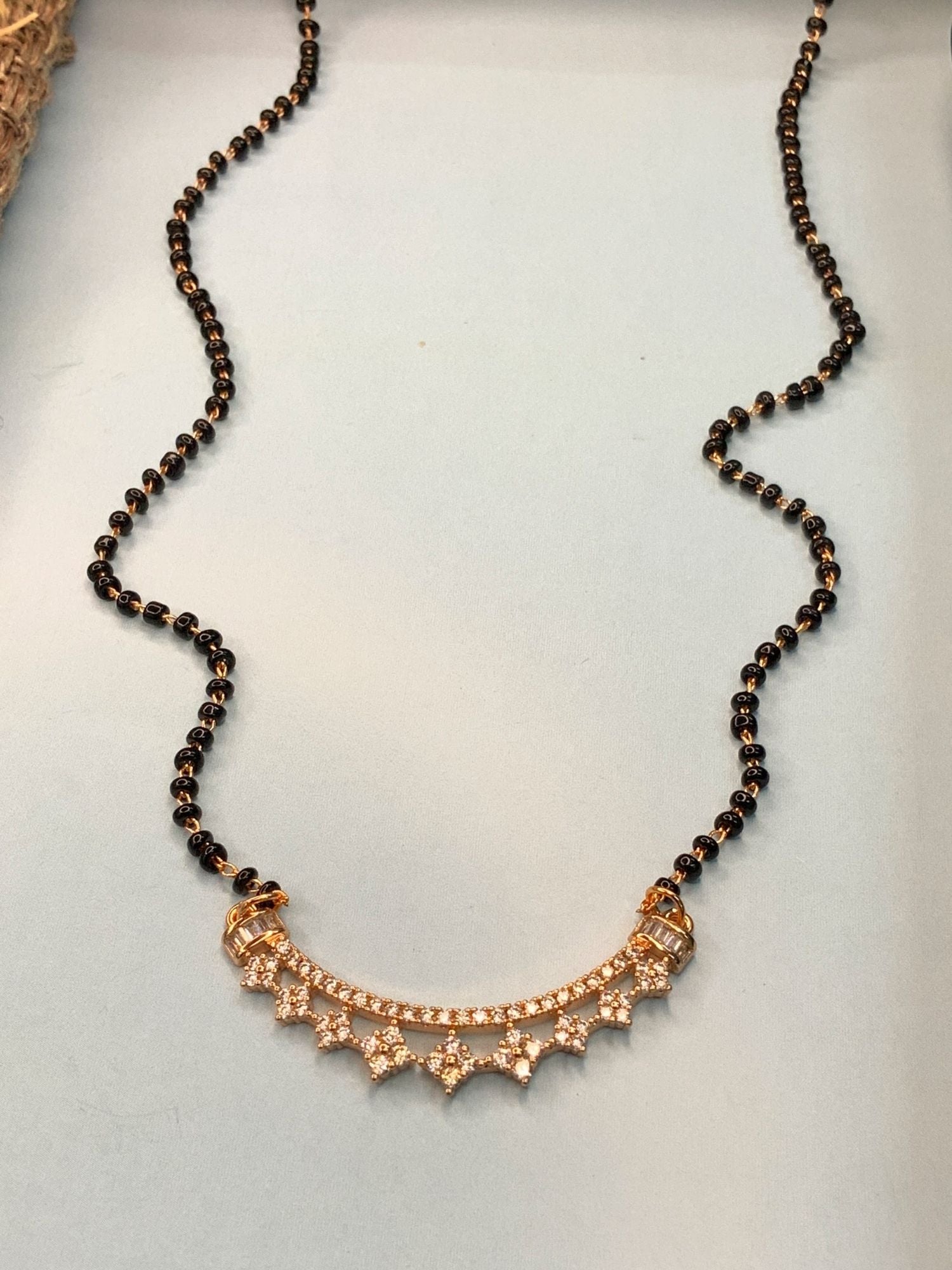 Abdesignsjewellery rose gold plated mangalsutra with black beads and crescent pendant studded with crystals