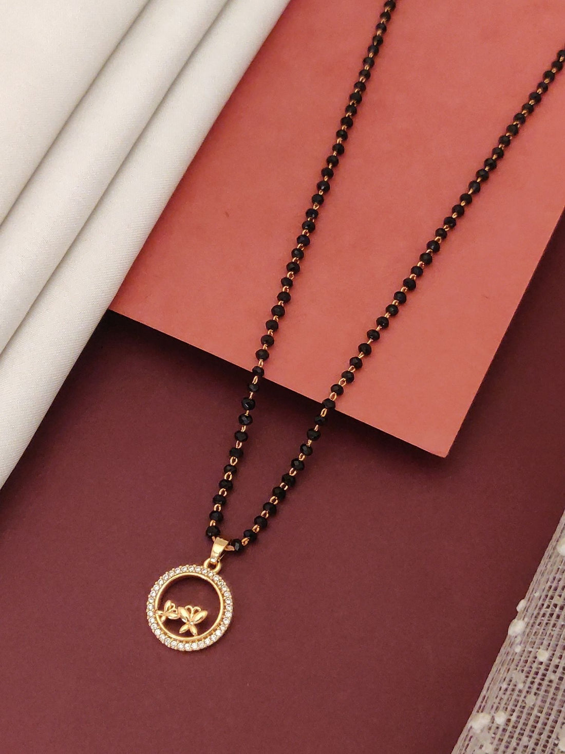 rosegold flower mangalsutra for women by Abdesignsjewellery black beaded chain with circular crystal halo pendant