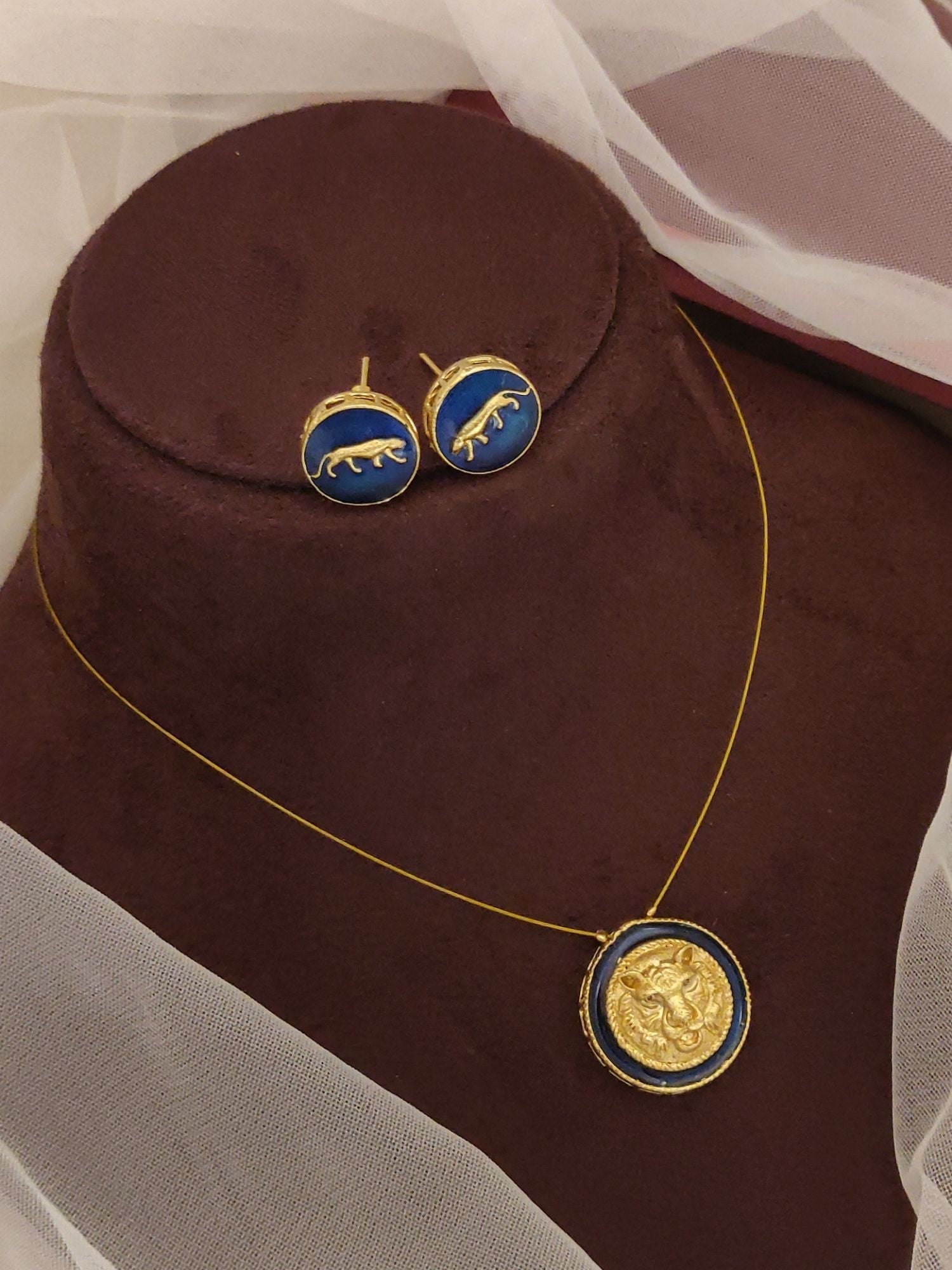 Sabyasachi inspired necklace earrings set gold chain with blue enamel coin pendant and matching stud earrings on brown bust