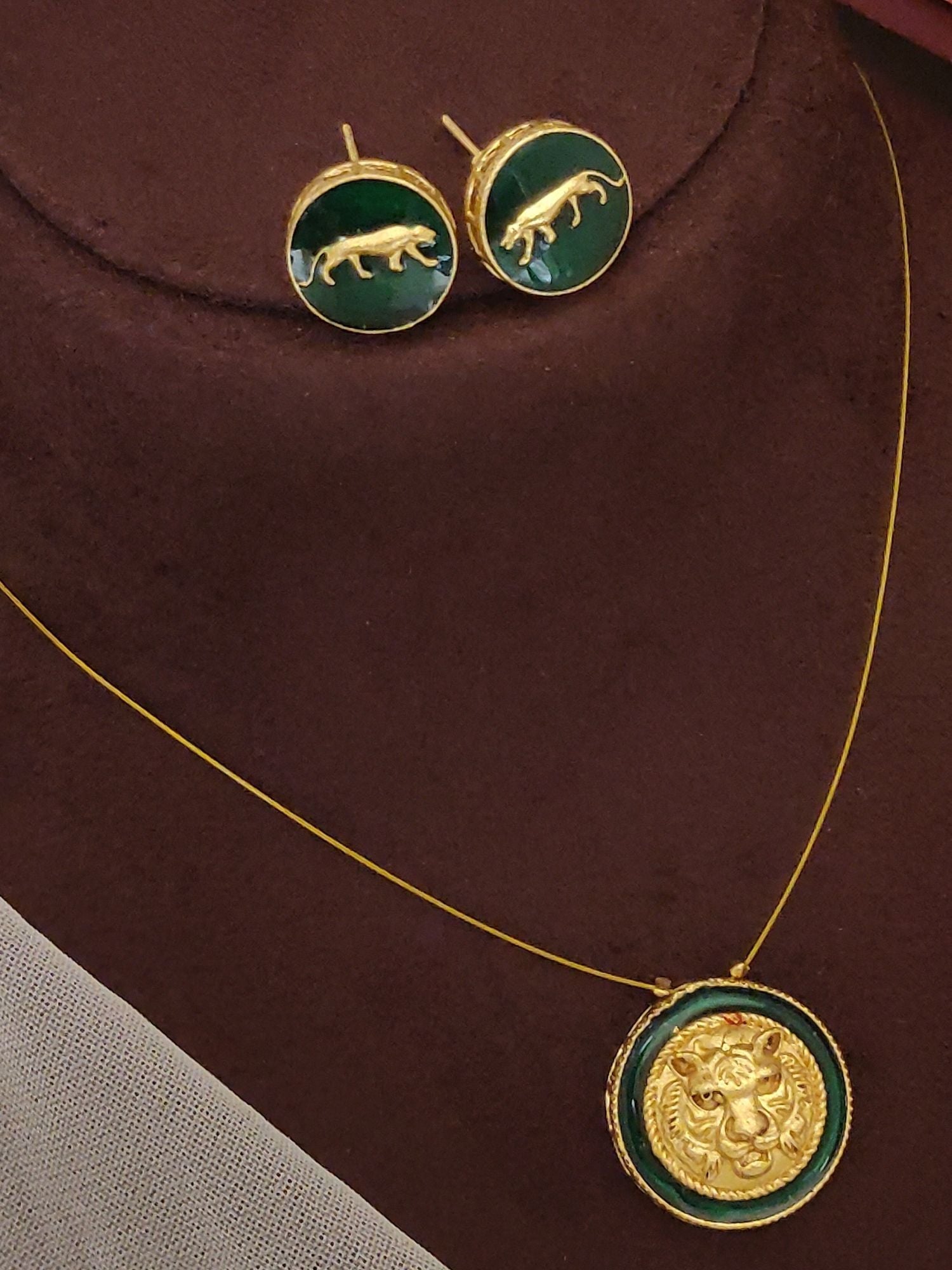 Gold pendant chain with green enamel lion medallion and matching stud panther earrings Sabyasachi inspired necklace earrings set