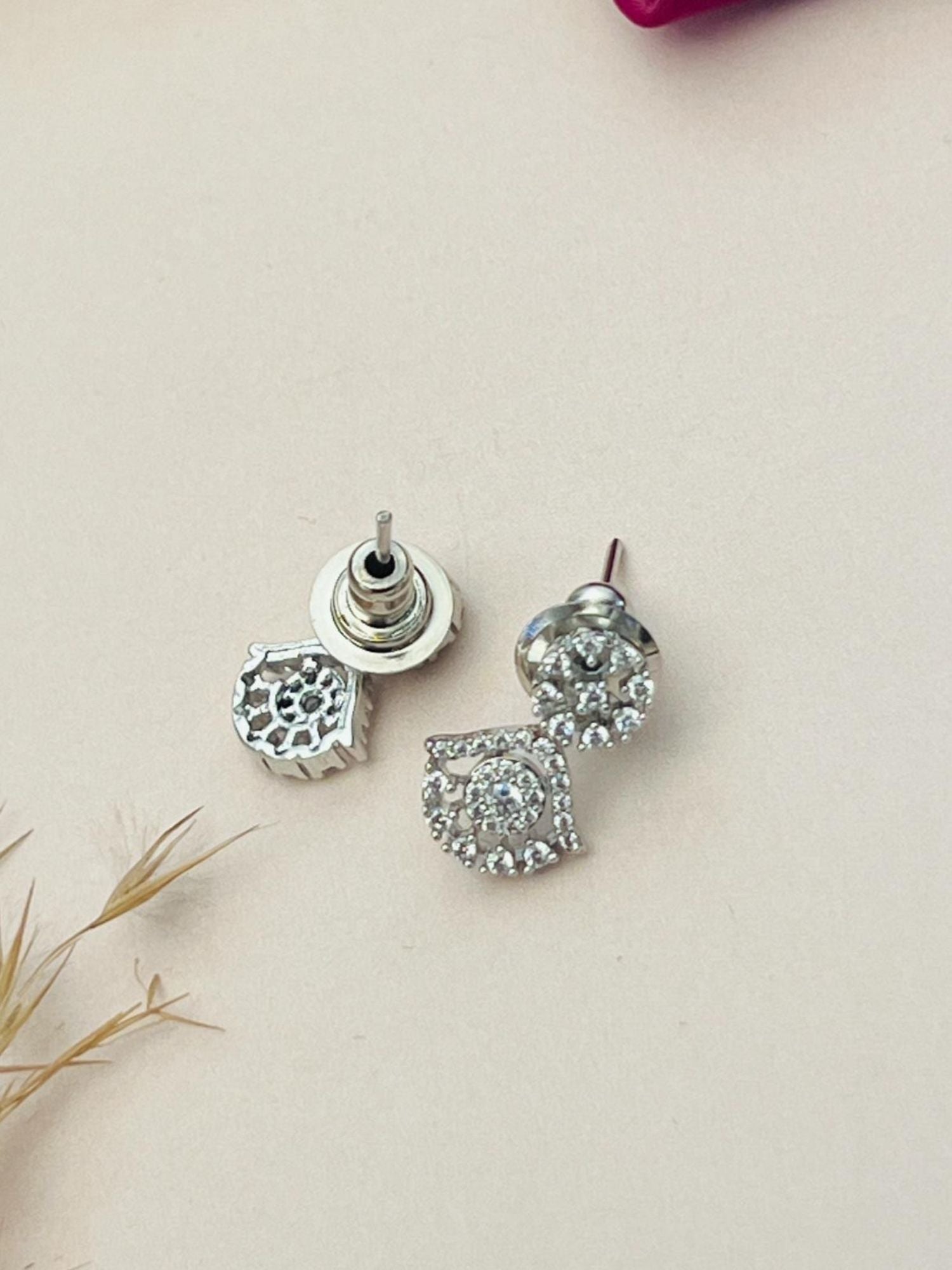 Silver Plated American Diamond Mangalsutra With Earrings square and round diamond cluster studs on beige background