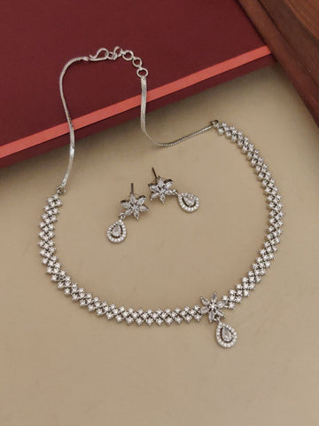Abdesignsjewellery silver plated American diamond necklace set with floral drop earrings on beige background