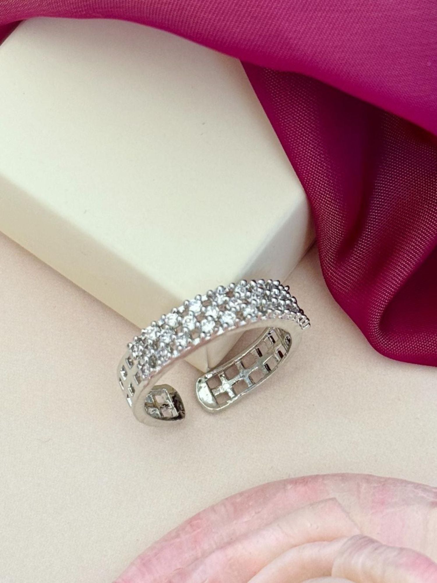 Abdesignsjewellery silver plated American diamond ring open adjustable pave band on pink fabric
