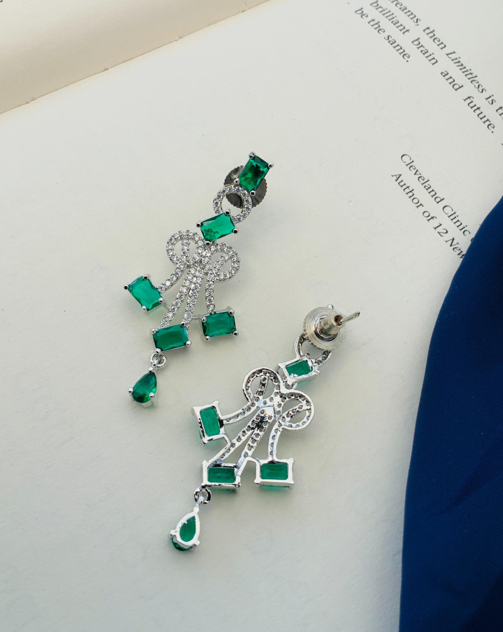 Abdesignsjewellery Silver Plated Blue American Diamond Necklace Set with green gemstone earrings on a white book background