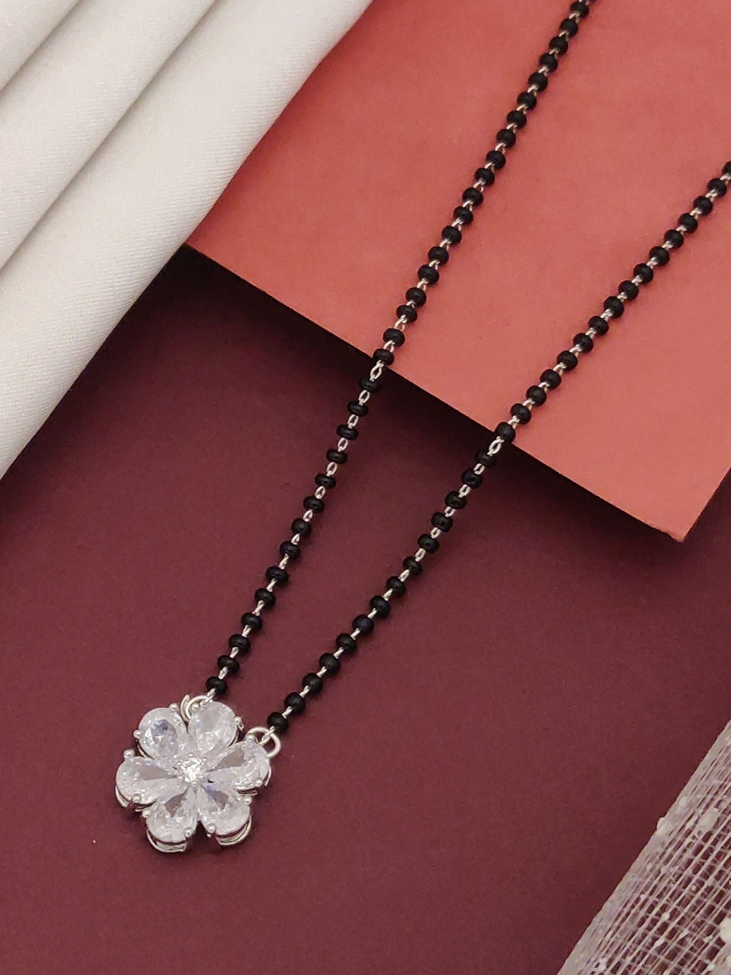 Silver Plated flower mangalsutra with black beads and crystal encrusted silver flower pendant by Abdesignsjewellery