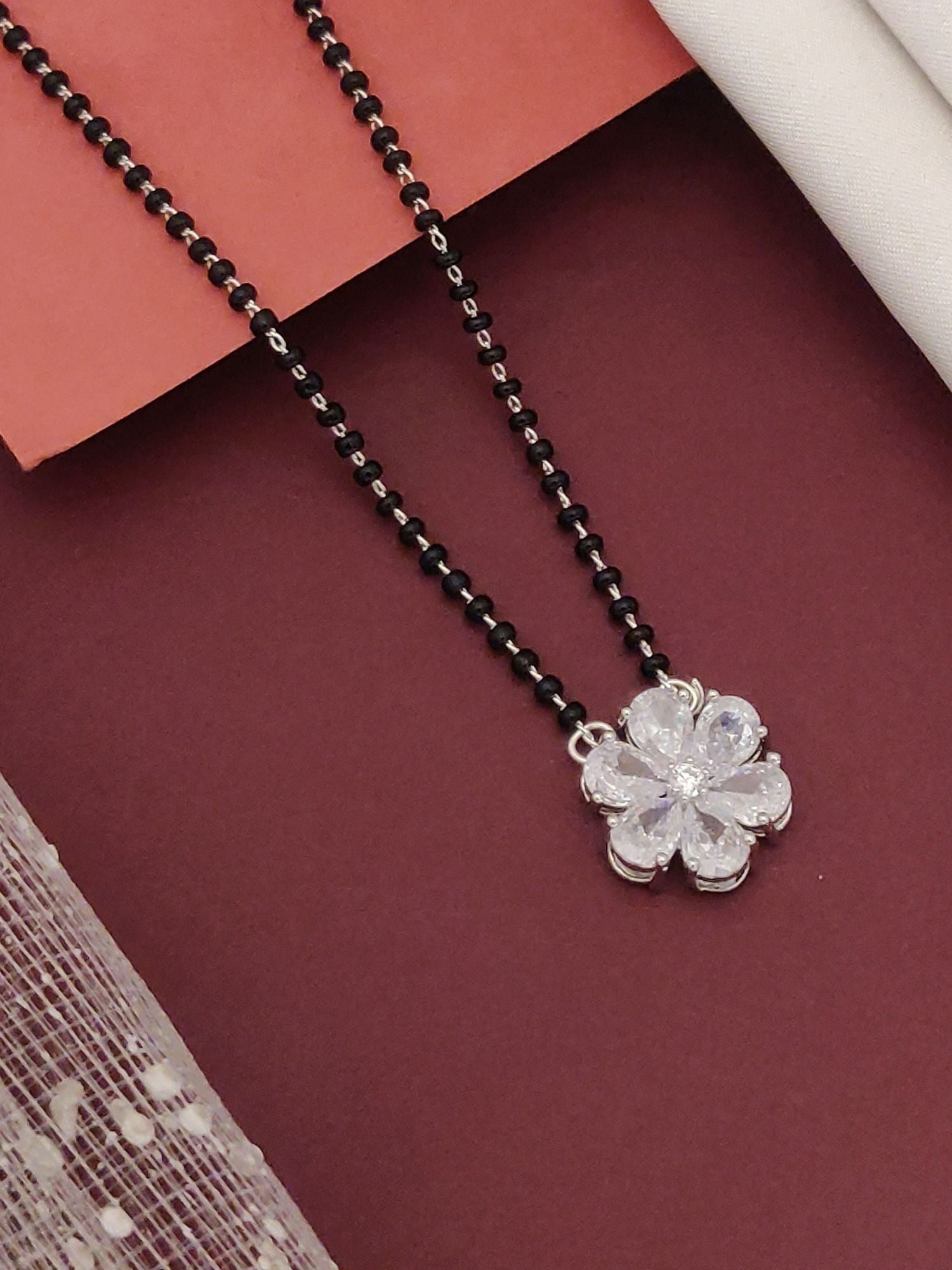 Silver Plated flower mangalsutra with delicate silver flower pendant and traditional black beads by Abdesignsjewellery