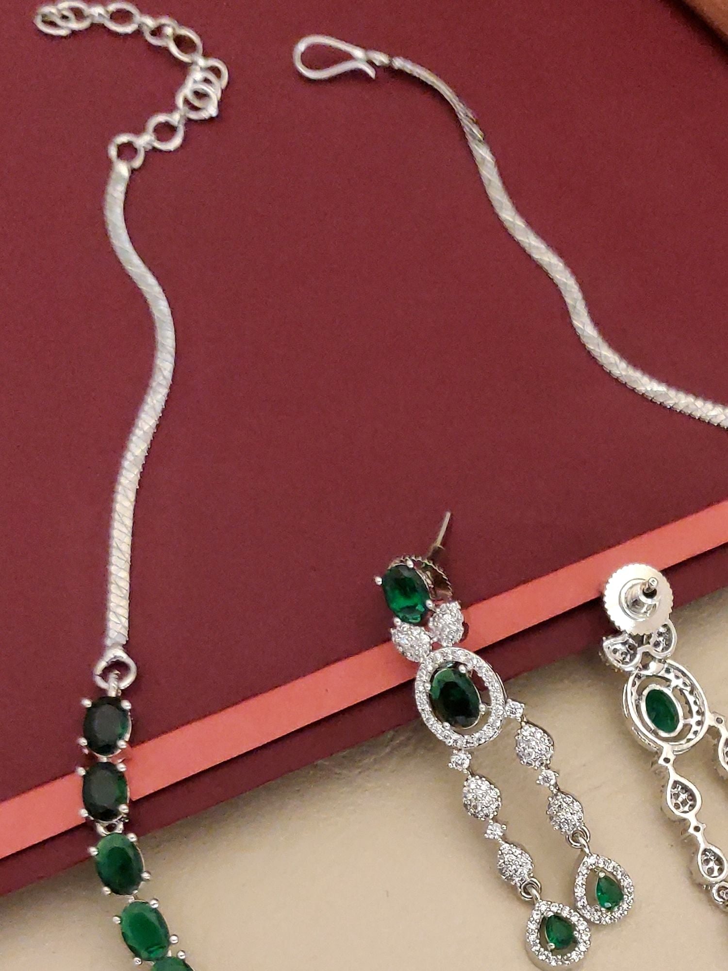 Silver Plated Green American Diamond Necklace Set featuring oval green stones on silver chains with matching earrings
