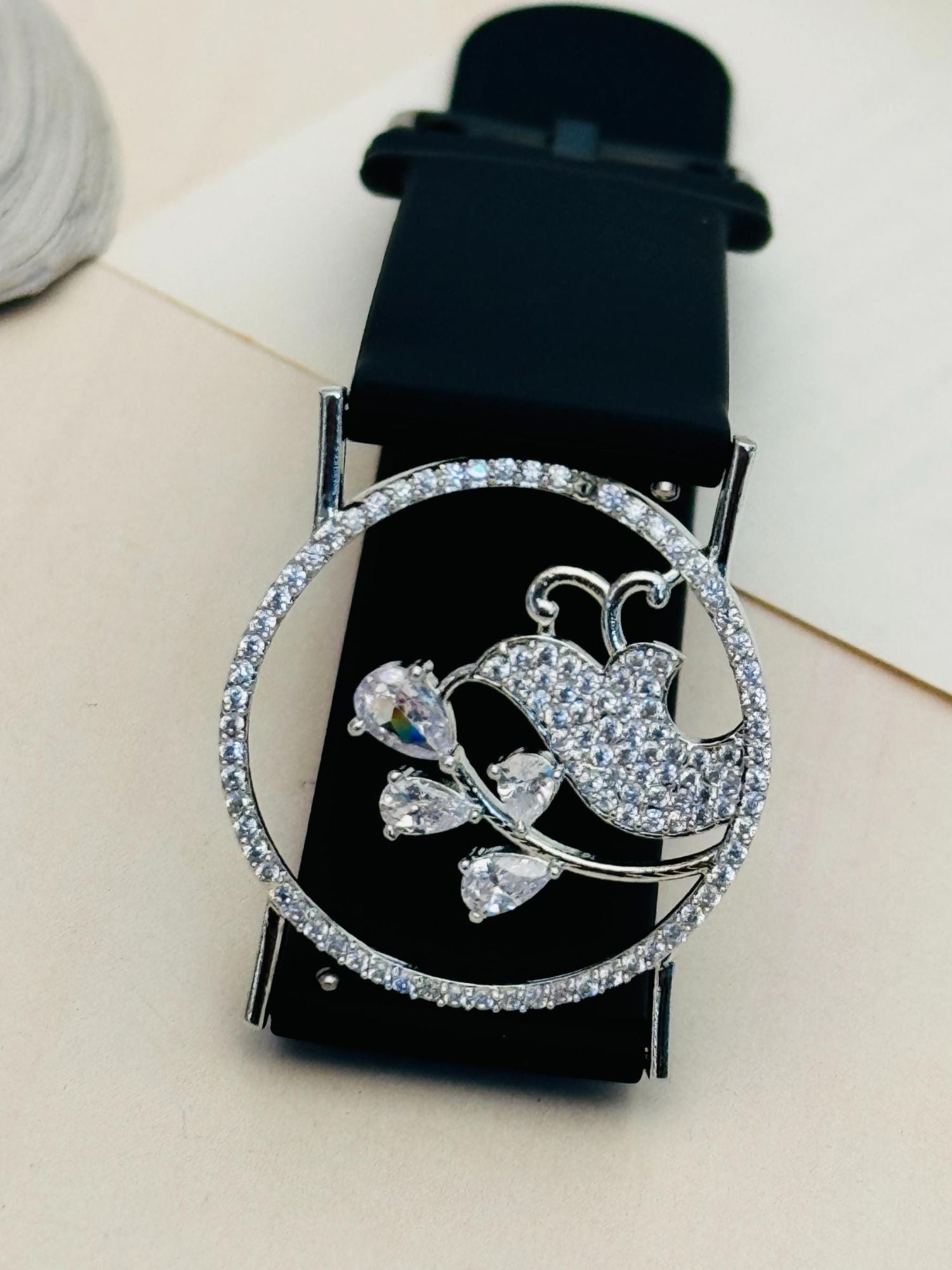 silver plated hand belt bracelet by Abdesignsjewellery with crystal encrusted bird and floral circle on black strap