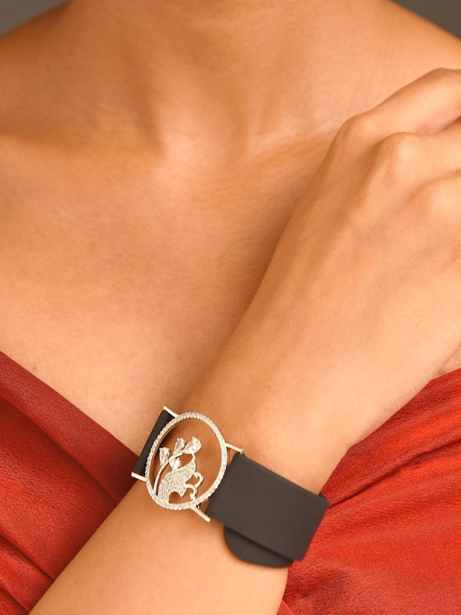 Abdesignsjewellery silver plated hand belt bracelet with black silicone strap and floral circular silver buckle on wrist