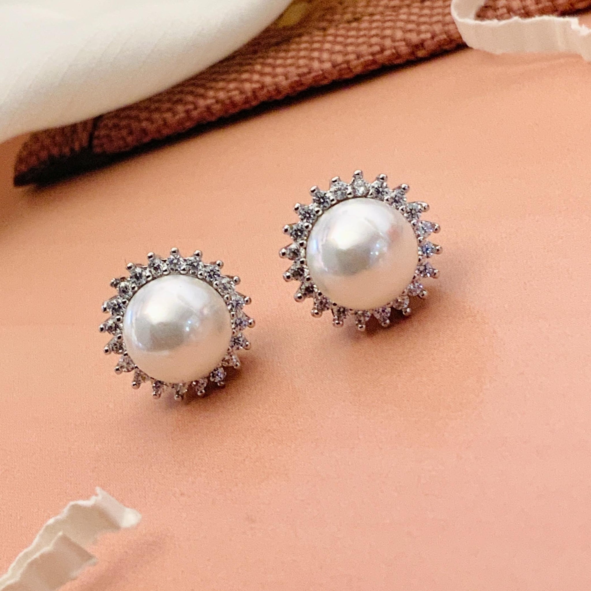 Abdesignsjewellery silver plated pearl stud earrings pair with crystal halo in silver setting on peach backdrop