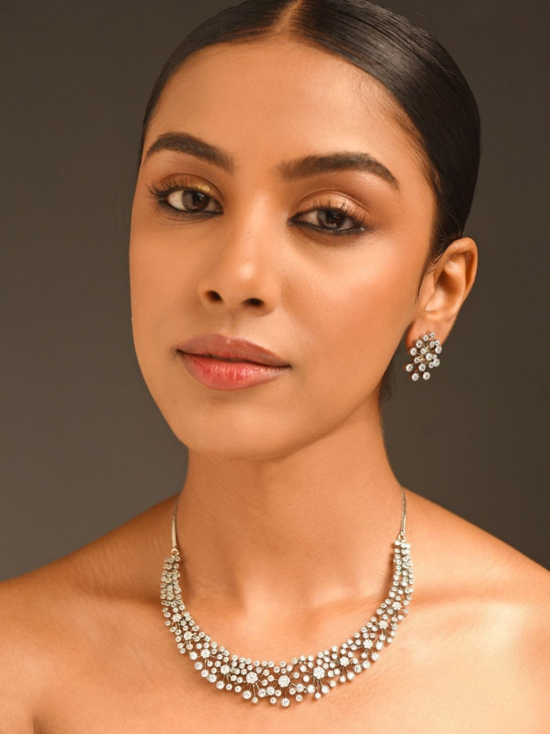 Abdesignsjewellery model wearing silver rhinestone necklace for women with matching stud earrings