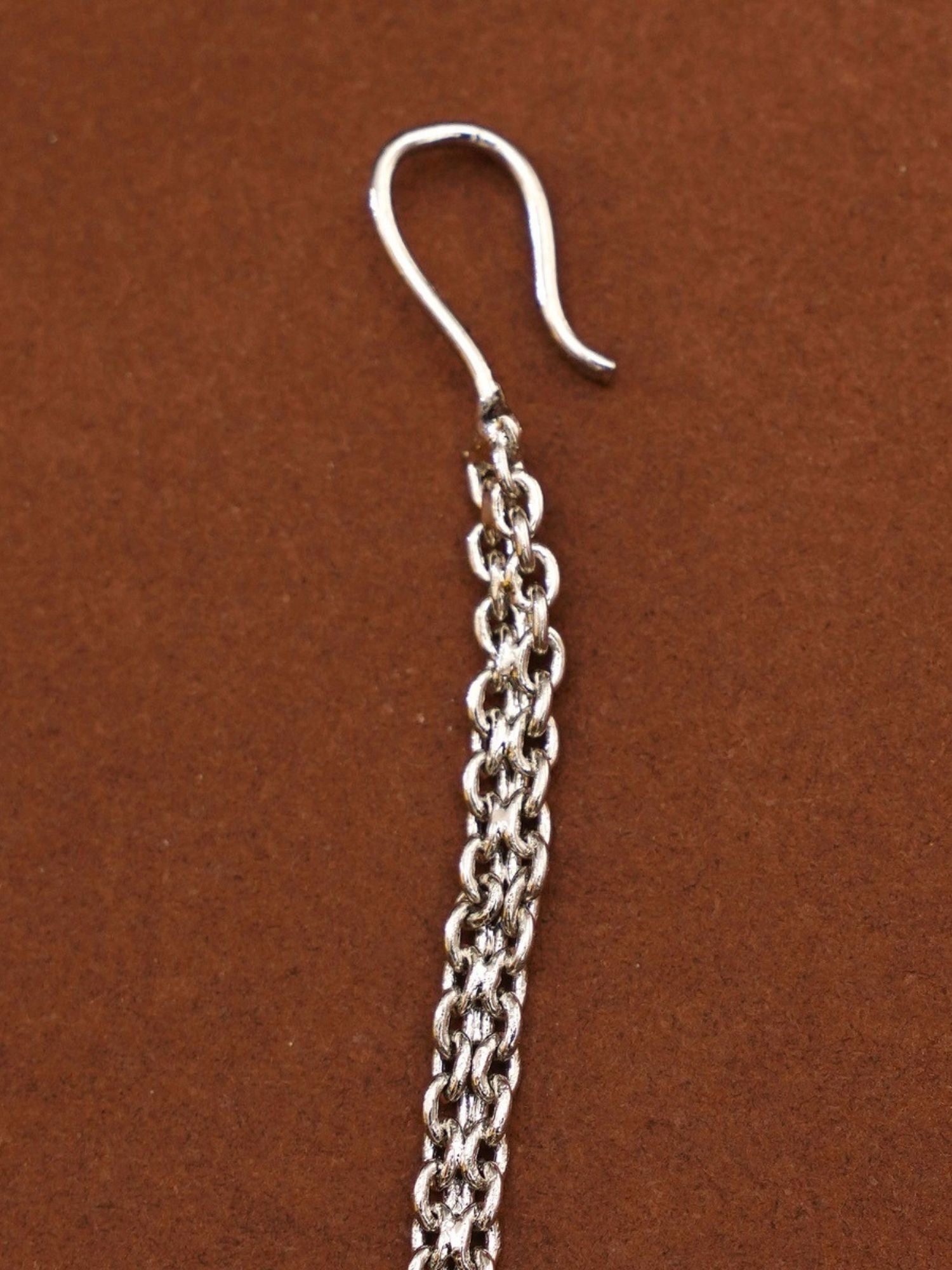 Solitaire diamond maangtikka silver braided chain with hook by Abdesignsjewellery on brown background