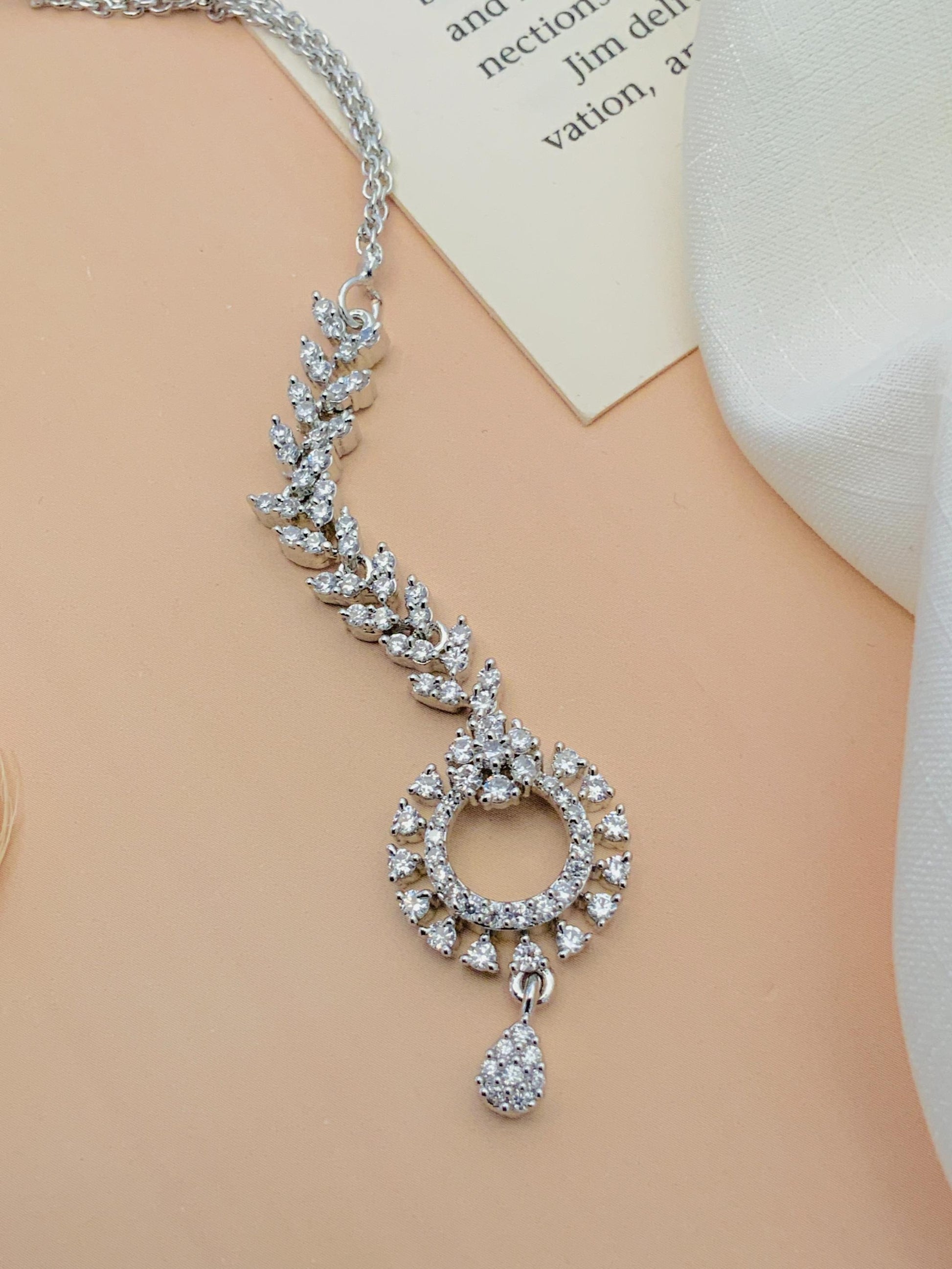 Timeless Silver Plated American Diamond Maangtikka with intricate leaf design and round pendant